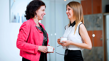 Two co-workers laughing and talking