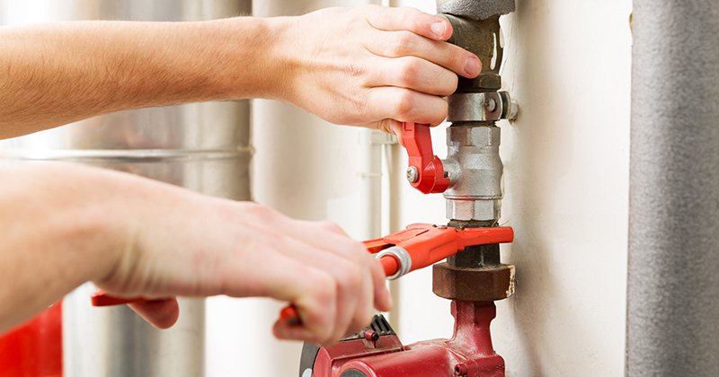 Closeup of plumber hands working with pipeline connections