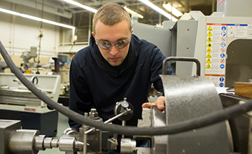 A student working with machinery