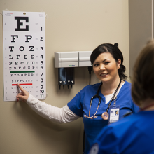 Medical Assistant student using eye exam chart