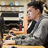 Young male student uses a computer in the Learning Commons 