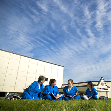 Group of nursing students studying in the lawn of the WITC-Superior campus