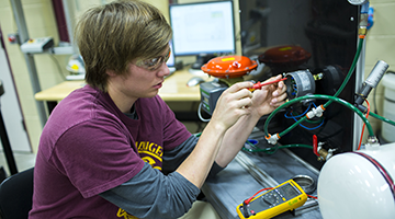 A student working hands-on in the lab