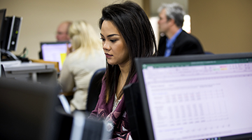 Financial Services student studying at a computer.