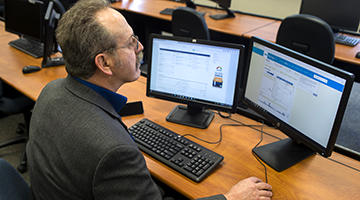 A student looking at stocks on the computer