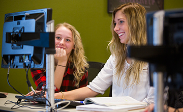 Two students looking at a computer