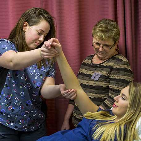 Students practicing the skills that nursing assistants use