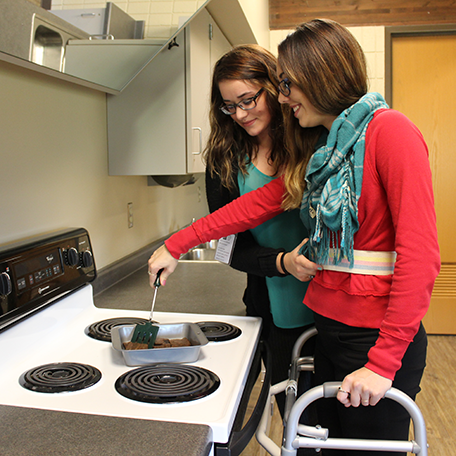 Students practicing how to assist someone in the kitchen