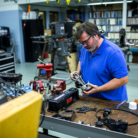 Marine repair student working with tools in the marine repair lab