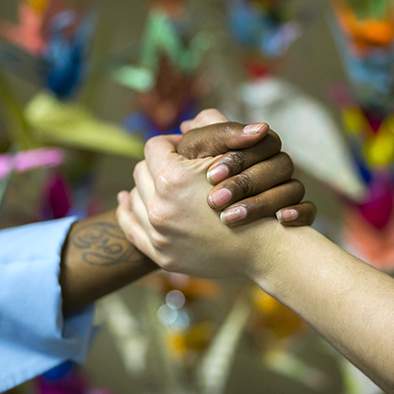 Two people holding hands in a triumphant way