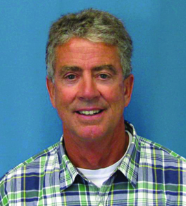 Image of board member Dennis Early wearing a plaid shirt