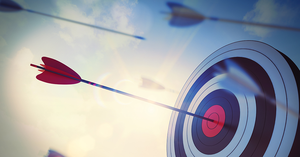 Target with arrows flying by and on the bulls-eye