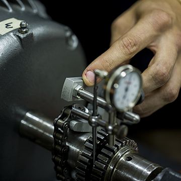 Close up of a hand working on a machine