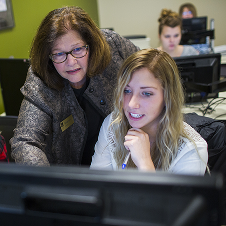 An instructor helping a student on the computer