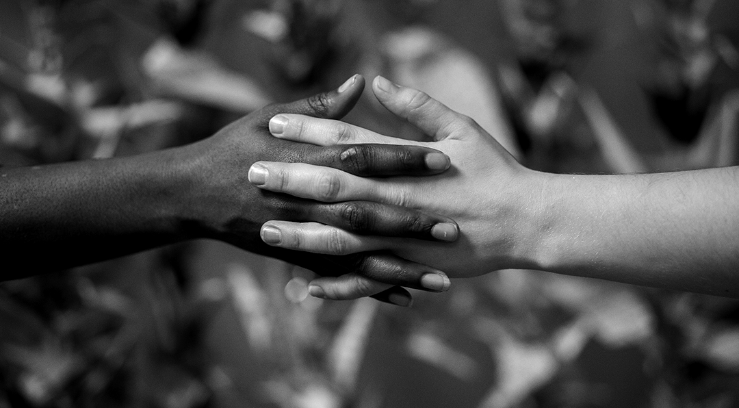 Two hands intertwined in partnership