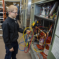 A student doing hands-on work in the HVAC industry