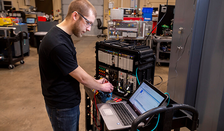 An automation student learning in the lab