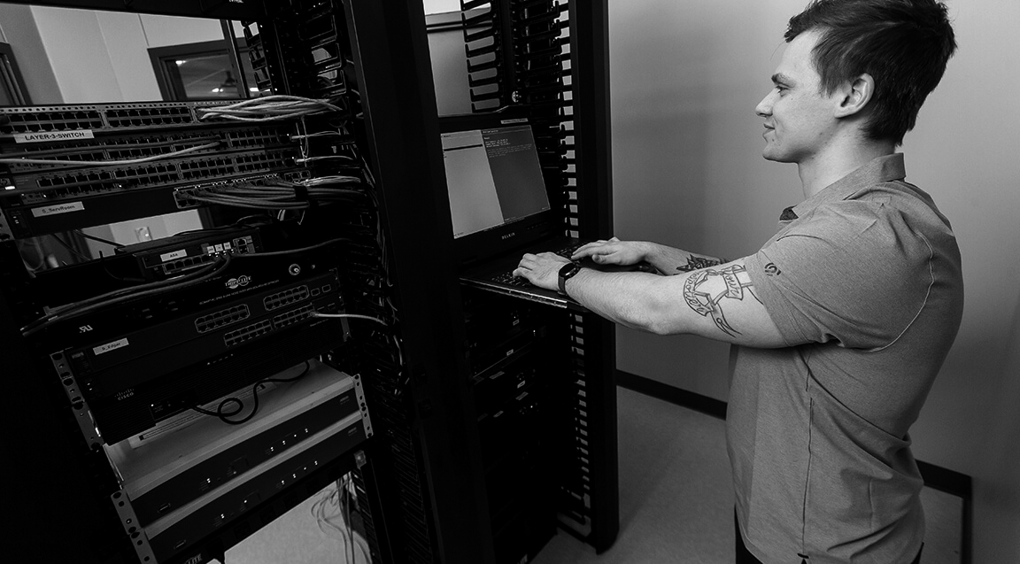 An IT student doing hands-on work in the classroom