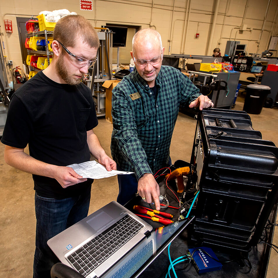 Student with instructor doing hands-on work in the automation lab