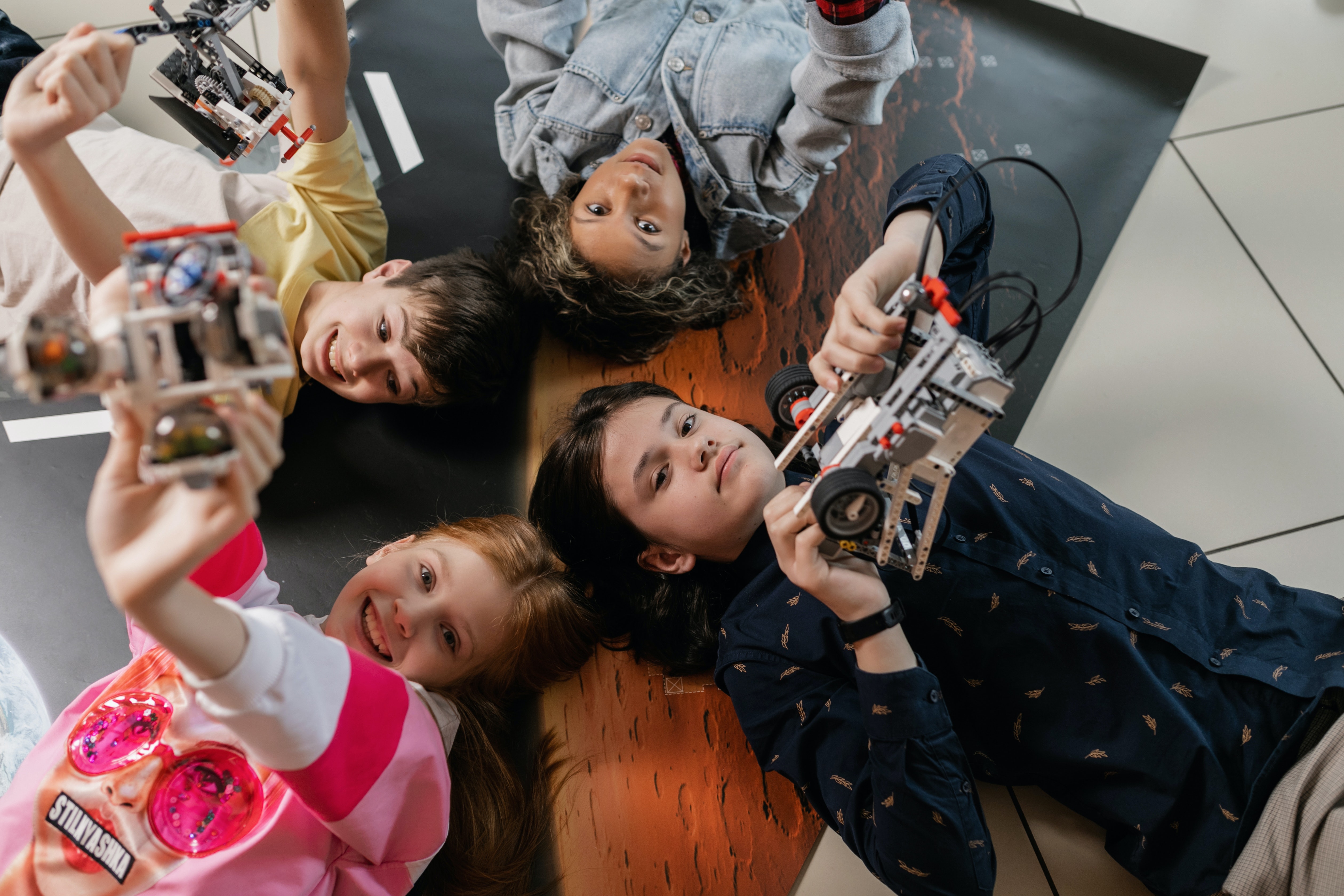 group of children holding up lego robots