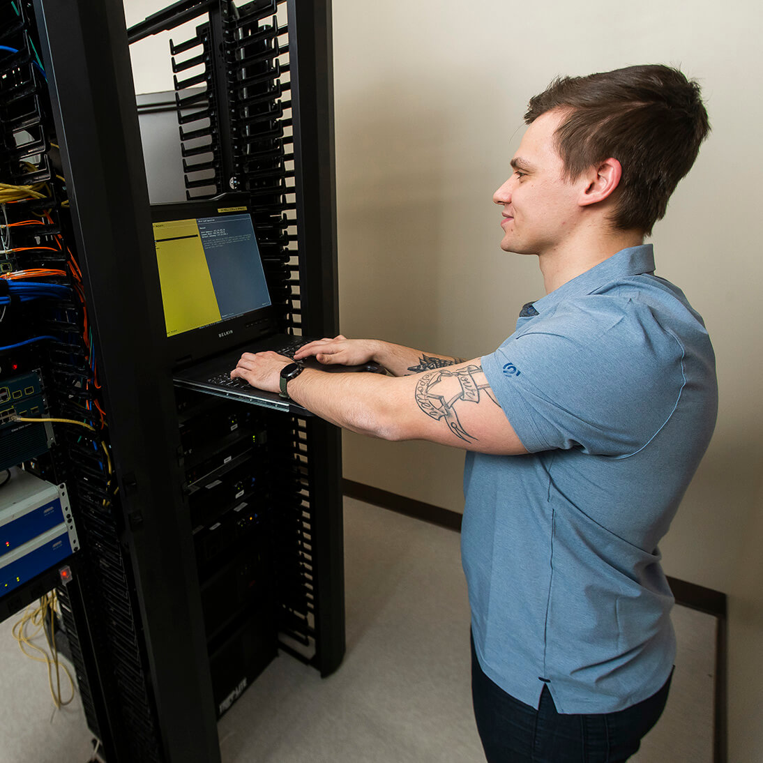 An IT student doing hands-on work in the classroom