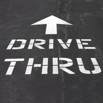 Drive Thru with arrow spray painted on the road