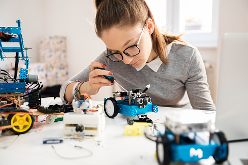 young student working on a model car