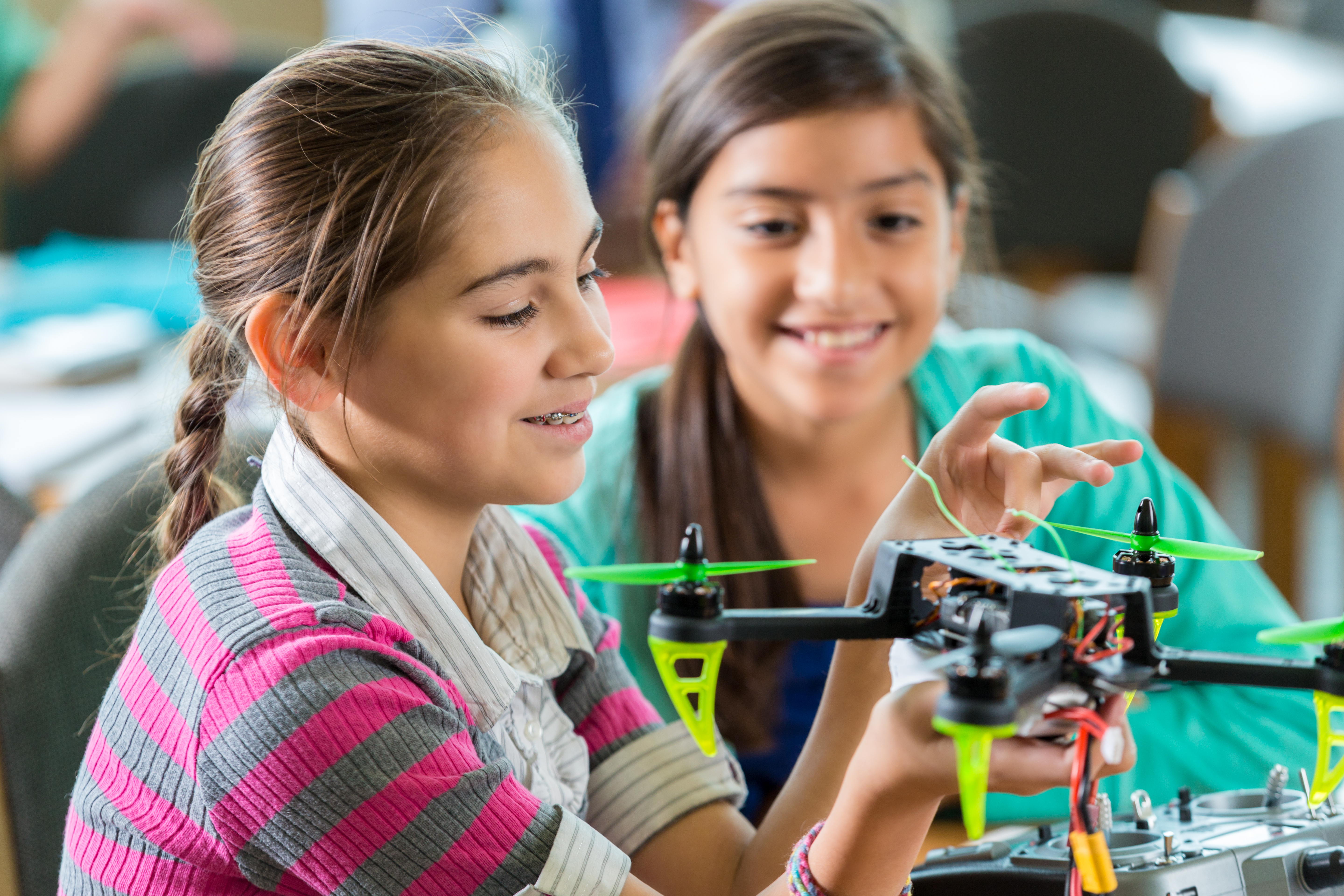 two young students working on a robotic drone