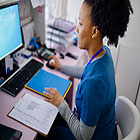 A medical administrative professional at her computer station