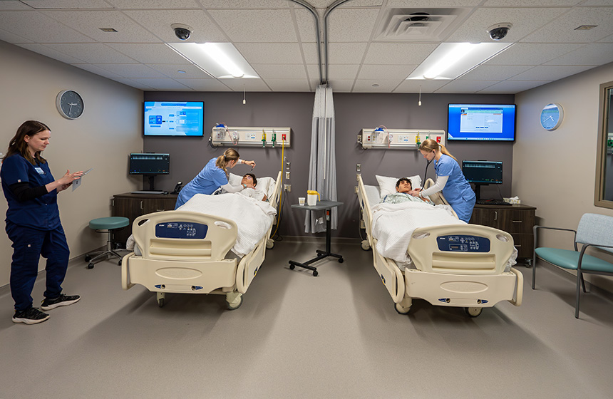 Nurses work in in a hospital-like setting with hi-fidelity manikins of adults
