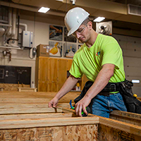 A construction student doing hands-on work