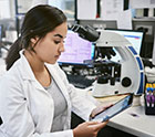 young woman using a digital tablet while working in a laboratory