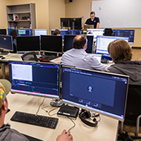 IT students in the classroom listening to instructor