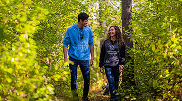 students walking on a trail by campus