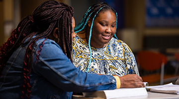 Two students studying in commons area