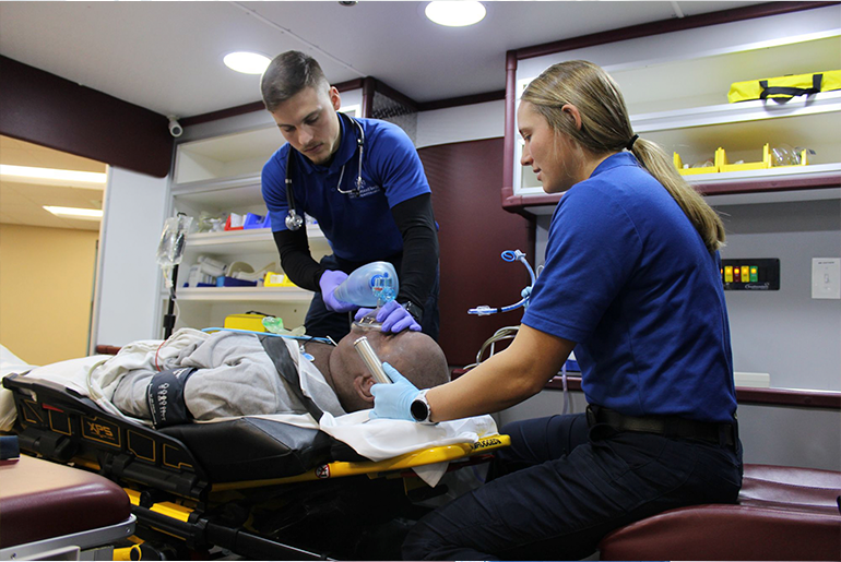 two EMS providers work on trauma patient