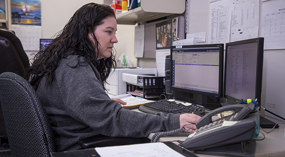 A medical administrative professional looking at a computer