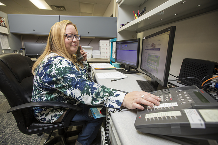 A medical administrative professional making a phone call