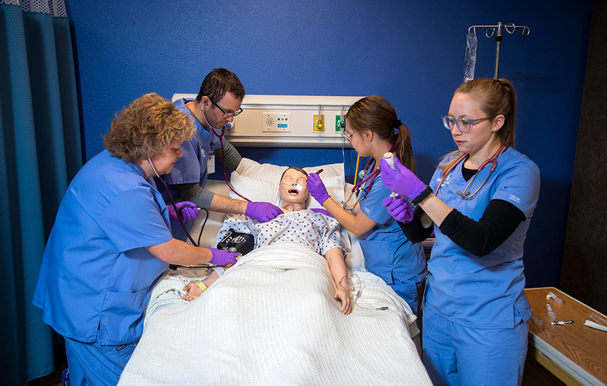 Group or nursing students working with a simulator
