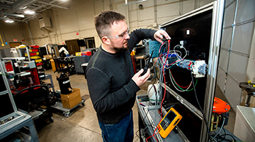 Student working with technology in the automation lab