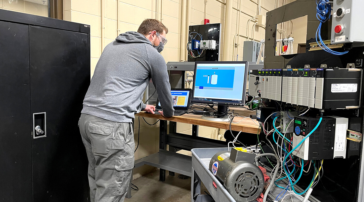 A student doing hands-on work in the automation lab