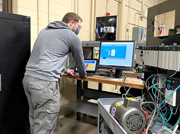 A student doing hands-on work in the automation lab