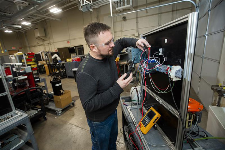 Student working with technology in the automation lab