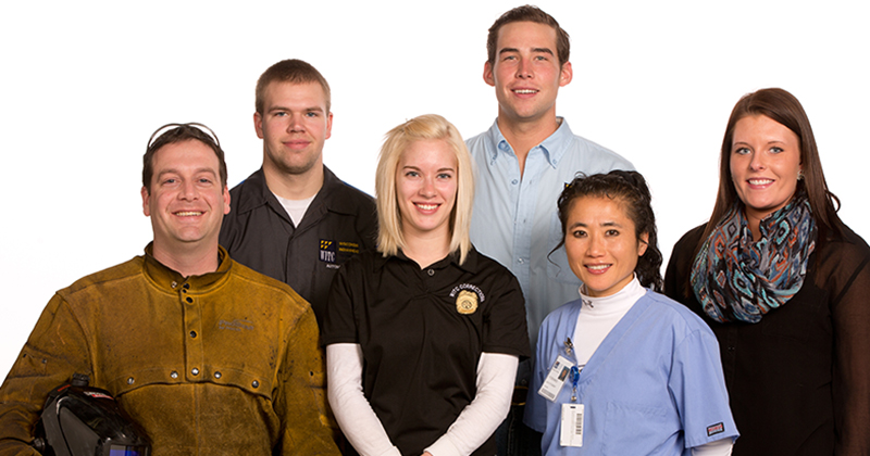 Students from various programs Students from various programs wearing their career outfits smile against a white background