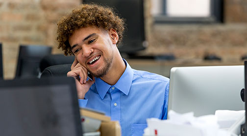 Business man on the phone smiling