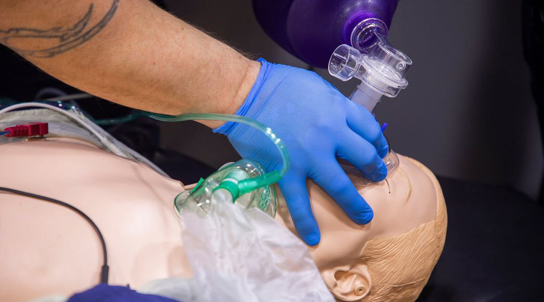 EMT students doing hands-on work with a simulated person