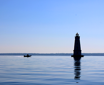 Silhouette of lighthouse and boat on Lake Superior Silhouette of lighthouse and boat on Lake Superior