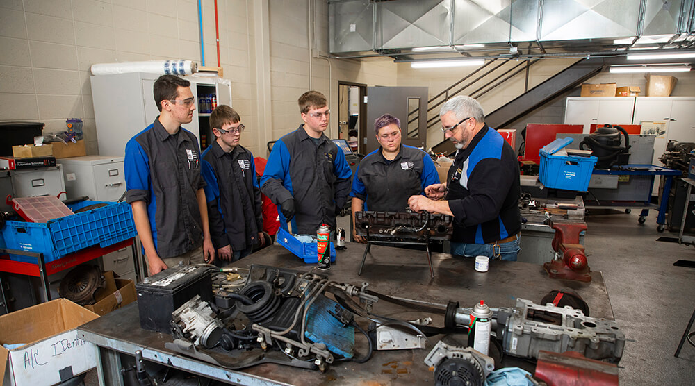 Automotive students listening to instructor in the shop