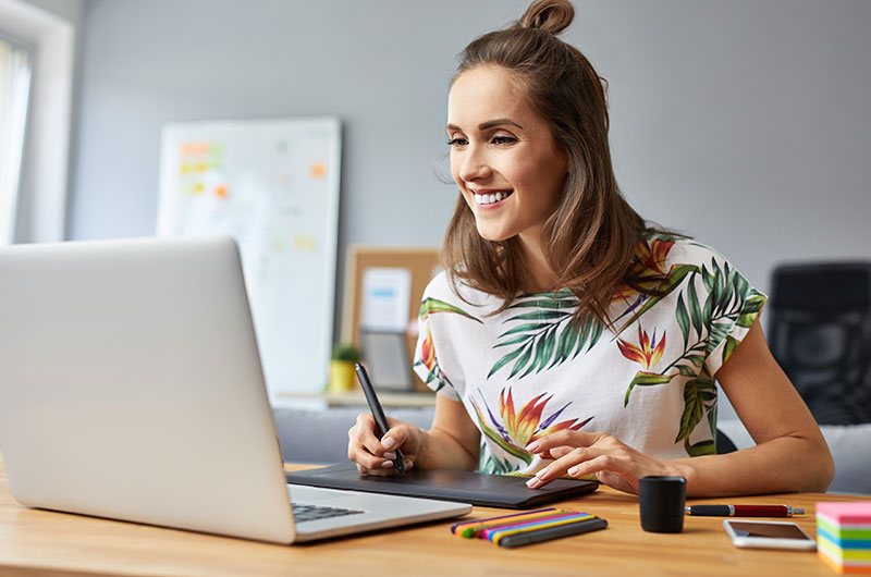 A graphic designer working on a project with laptop