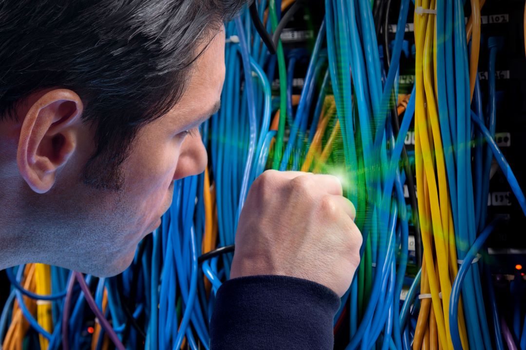 Broadband student working with server cables